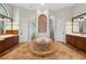 Luxurious bathroom with a round soaking tub, mosaic tile accents, and separate vanities for convenience at 1716 Greystone Ct, Longwood, FL 32779