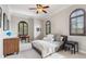 Neutral bedroom with arched windows, crown molding, ceiling fan, and a grey bedframe at 1716 Greystone Ct, Longwood, FL 32779
