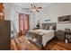 Cozy bedroom with hardwood floors, a ceiling fan, and a comfortable bed with stylish decor at 1716 Greystone Ct, Longwood, FL 32779