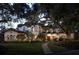 Stunning Mediterranean-style home with lush landscaping, mature trees, and a grand entrance at 1716 Greystone Ct, Longwood, FL 32779