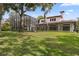 Exterior view of a home showing the backyard, screened pool, patio, and architectural style at 1716 Greystone Ct, Longwood, FL 32779