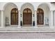 Elegant front entrance featuring arched doorways, stately columns, and a classic Mediterranean design at 1716 Greystone Ct, Longwood, FL 32779