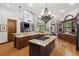 Spacious kitchen with granite countertops, a central island, and dark wood cabinetry at 1716 Greystone Ct, Longwood, FL 32779