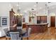 Open kitchen and breakfast nook with custom cabinets, stainless steel appliances, and granite countertops at 1716 Greystone Ct, Longwood, FL 32779
