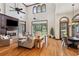 Bright living room with hardwood floors, fireplace, and access to the outdoor living area at 1716 Greystone Ct, Longwood, FL 32779