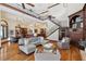 Spacious open-concept living area and breakfast nook with hardwood floors and a staircase at 1716 Greystone Ct, Longwood, FL 32779