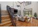 Grand living room with a decorative staircase, high ceilings, and an open floor plan to the outdoor spaces at 1716 Greystone Ct, Longwood, FL 32779