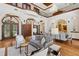 Bright living room with soaring ceilings, arched doorways, and elegant furnishings at 1716 Greystone Ct, Longwood, FL 32779
