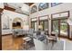 Open-concept living area featuring hardwood floors, a soaring ceiling, elegant lighting, and seamless access to outdoor areas at 1716 Greystone Ct, Longwood, FL 32779