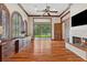 Sunlit den with fireplace, hardwood flooring, and custom cabinetry at 1716 Greystone Ct, Longwood, FL 32779