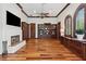 Elegant living room featuring hardwood floors, a fireplace, and custom built-in cabinetry with crown molding at 1716 Greystone Ct, Longwood, FL 32779