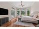 Serene primary bedroom featuring a tray ceiling, floor to ceiling windows, and access to the outdoor pool at 1716 Greystone Ct, Longwood, FL 32779