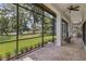 Covered patio with comfortable seating overlooking the lush backyard at 1716 Greystone Ct, Longwood, FL 32779