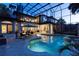 Beautiful private pool with screened enclosure, poolside seating, and manicured landscaping at 1716 Greystone Ct, Longwood, FL 32779