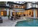 A gorgeous backyard featuring a screened-in pool, lounge chairs, and an umbrella covered table at 1716 Greystone Ct, Longwood, FL 32779