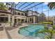 Beautiful backyard featuring a large pool, patio seating, and a screened enclosure at 1716 Greystone Ct, Longwood, FL 32779