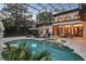 Screened pool area with a pool, patio furniture, and lush landscaping surrounding the pool at 1716 Greystone Ct, Longwood, FL 32779