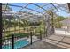 View of pool and golf course from spacious screened in lanai with black aluminum framing at 1716 Greystone Ct, Longwood, FL 32779