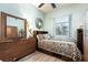 Cozy bedroom with natural light, wood floors, and an accent mirror at 1718 Elaine Ave, Altamonte Springs, FL 32701