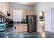 Functional kitchen featuring wooden cabinets, stainless appliances and a laundry room for added convenience at 1718 Elaine Ave, Altamonte Springs, FL 32701