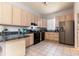 Functional kitchen featuring wooden cabinets, black appliances, and plenty of counter space for meal preparation at 1718 Elaine Ave, Altamonte Springs, FL 32701