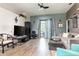 Spacious living area with hardwood floors, comfortable seating, and access to outdoor entertainment space at 1718 Elaine Ave, Altamonte Springs, FL 32701