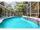 Screened pool with waterfall feature and landscaped surroundings at 1718 Elaine Ave, Altamonte Springs, FL 32701