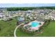 Aerial view of a community pool, park, and various single-Gathering homes at 1909 Donahue Dr, Ocoee, FL 34761