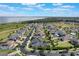 Scenic aerial shot of a neighborhood with a lake view, showcasing neatly arranged homes and landscaping at 1909 Donahue Dr, Ocoee, FL 34761