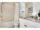 A neutral bathroom featuring a shower-tub combination and a vanity with a light gray countertop at 1909 Donahue Dr, Ocoee, FL 34761