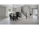 Elegant dining room featuring a chandelier, large window, and staircase at 1909 Donahue Dr, Ocoee, FL 34761
