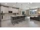 Modern kitchen with white cabinets, quartz countertops, and a large island with seating at 1909 Donahue Dr, Ocoee, FL 34761