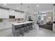 Modern kitchen with white cabinets, quartz countertops, and a large island with seating at 1909 Donahue Dr, Ocoee, FL 34761
