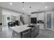 Open-concept kitchen with stainless steel appliances, a large island, and adjoining dining area at 1909 Donahue Dr, Ocoee, FL 34761