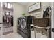 Laundry room with new washer and dryer, storage shelves, and a hanging rack at 1909 Donahue Dr, Ocoee, FL 34761