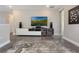 Entertainment area with TV and speakers on a credenza, and a large rug over the wood floor at 1909 Donahue Dr, Ocoee, FL 34761