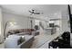 Open-concept living room with tile floors, a large sectional sofa, and an adjacent kitchen with an island at 1909 Donahue Dr, Ocoee, FL 34761