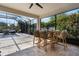 Enclosed patio area featuring a dining set and views of lush greenery and a pool at 1909 Donahue Dr, Ocoee, FL 34761