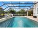 Beautiful screened-in pool with a hot tub and patio area at 1909 Donahue Dr, Ocoee, FL 34761