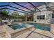 Beautiful screened-in pool with spa and ample seating area, perfect for relaxing and entertaining at 1909 Donahue Dr, Ocoee, FL 34761