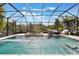 Sparkling pool area with comfortable lounge seating under a screened enclosure at 1909 Donahue Dr, Ocoee, FL 34761