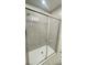 Modern bathroom featuring a glass door enclosed shower with tiled walls at 1912 Diamond Head Cir, Lake Hamilton, FL 33851