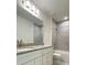 Bathroom featuring white vanity with gray granite countertop and tiled shower and tub at 1912 Diamond Head Cir, Lake Hamilton, FL 33851