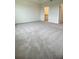 Spacious primary bedroom featuring neutral carpet and an en-suite bathroom entrance at 1912 Diamond Head Cir, Lake Hamilton, FL 33851