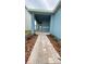 Inviting covered entrance with a brick walkway and colorful, drought-tolerant landscaping at 1912 Diamond Head Cir, Lake Hamilton, FL 33851