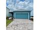 Home exterior featuring blue siding, a brick paver driveway, and a two car garage at 1912 Diamond Head Cir, Lake Hamilton, FL 33851
