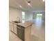 Open concept kitchen featuring an island with granite countertops and stainless steel dishwasher at 1912 Diamond Head Cir, Lake Hamilton, FL 33851