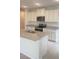 Bright kitchen with stainless steel appliances, granite countertops, and white cabinetry at 1912 Diamond Head Cir, Lake Hamilton, FL 33851