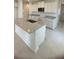 Bright kitchen with white cabinets, granite countertops, and stainless steel appliances at 1912 Diamond Head Cir, Lake Hamilton, FL 33851