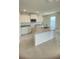 A well-lit kitchen boasts an island sink, white cabinets, granite counters, and modern appliances at 1912 Diamond Head Cir, Lake Hamilton, FL 33851